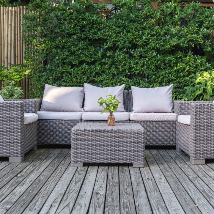 Large terrace patio with rattan garden furniture in the garden on wooden floor